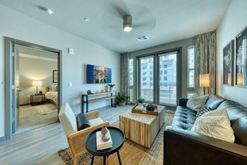 a living room with a couch coffee table and large windows